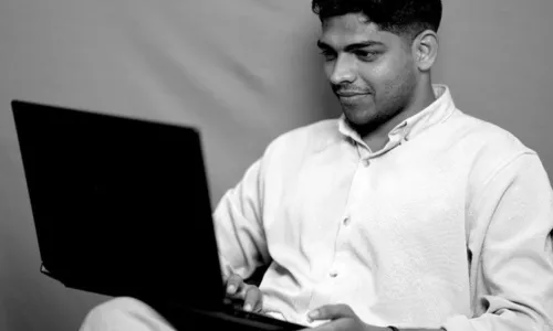 Brand consultant in Malappuram using a laptop for client brand strategy development